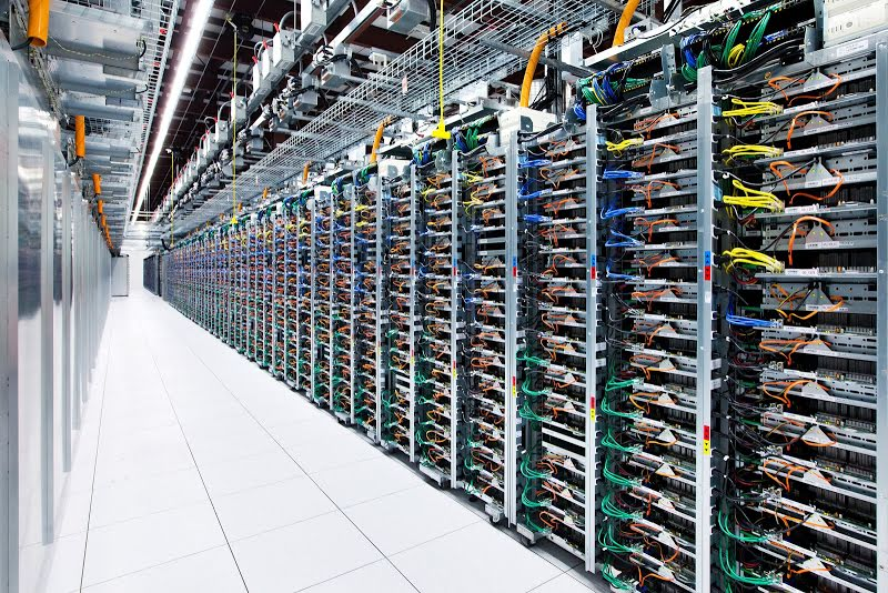 Image shows a long row of server racks at a Google data centre in Oklahoma